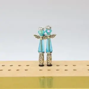 Decorative Chakra Angel cribbage pegs shaped with angel figures and accented in vibrant chakra colors, designed for use with a cribbage board.”