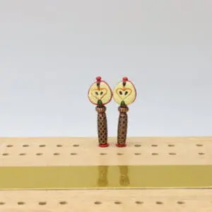 Handcrafted red apple-shaped cribbage pegs with a glossy finish, featuring detailed stems and leaf accents, designed for use with cribbage boards as decorative and functional game markers.