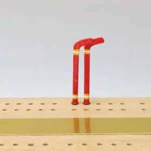 Hockey stick–shaped cribbage pegs designed with detailed sports-themed craftsmanship, ideal for custom cribbage boards and hockey enthusiasts.